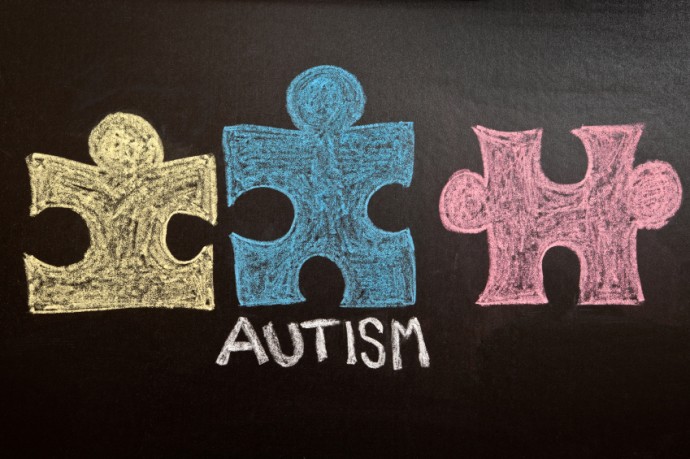 Colorful Autism Awareness Puzzle Pieces on Chalkboard